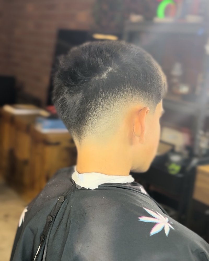 Low taper fade with a textured top, back view