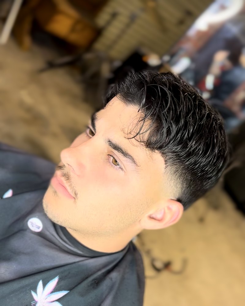 Taper fade with a textured side-swept fringe, side view