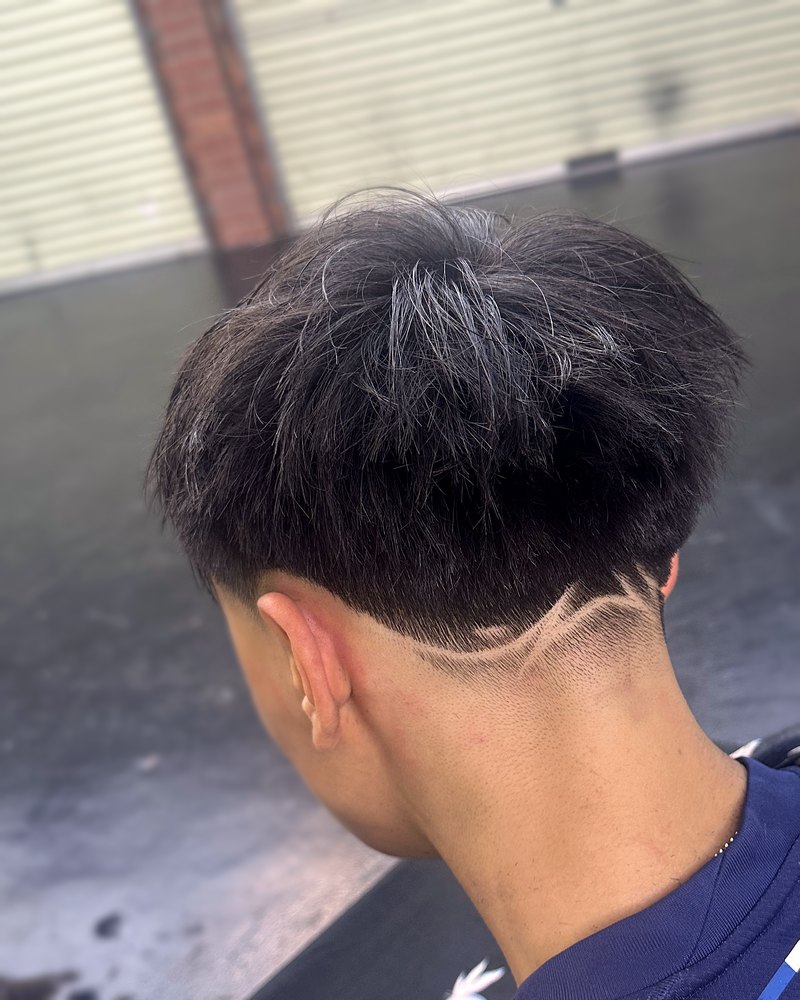 Textured crop with a razor-drawn wave line at the nape, back view
